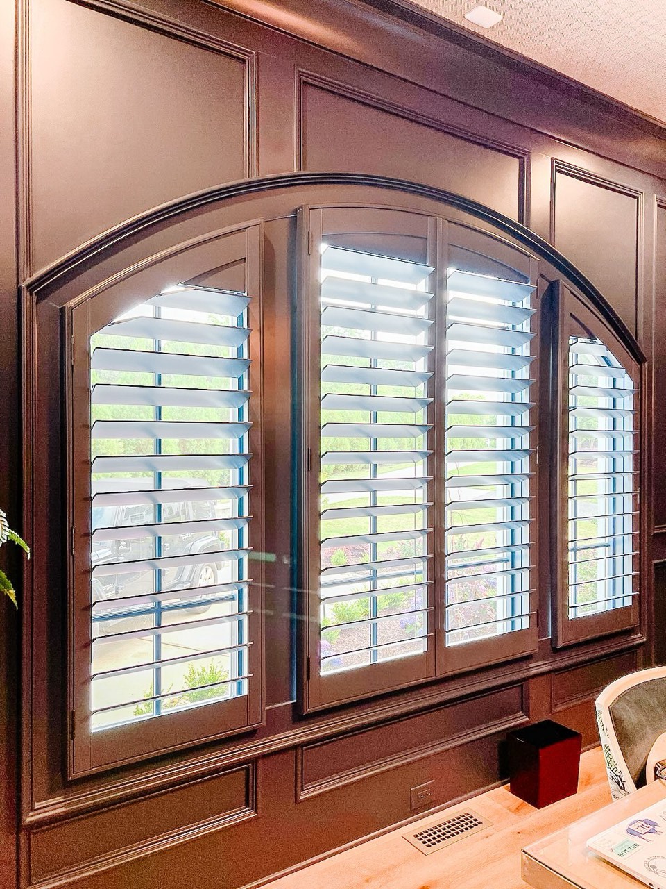 Four-panel arch-top plantation shutters