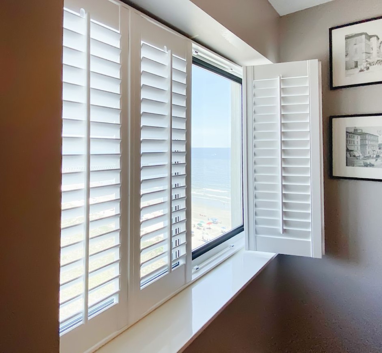 Bifold plantation shutters folded against the sides of a window