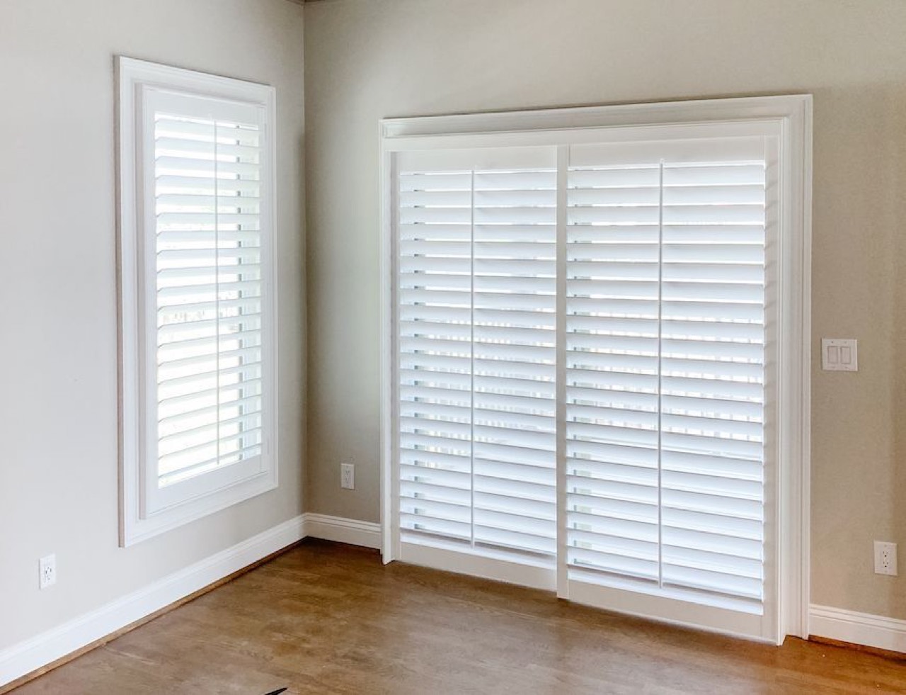 Two-panel bypass track shutter over a sliding glass door