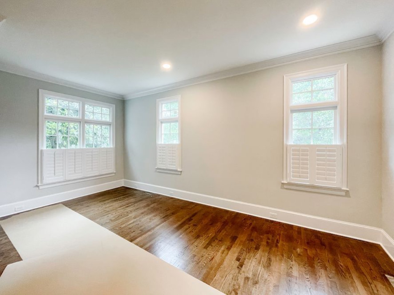 Full bedroom of café-height plantation shutters