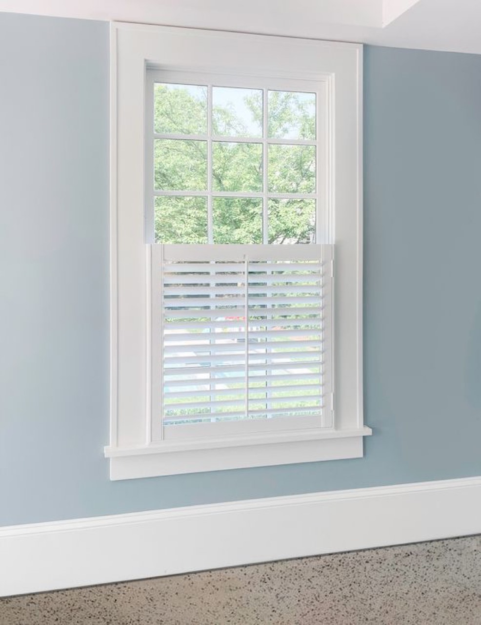 Café shutters in a garage-conversion window